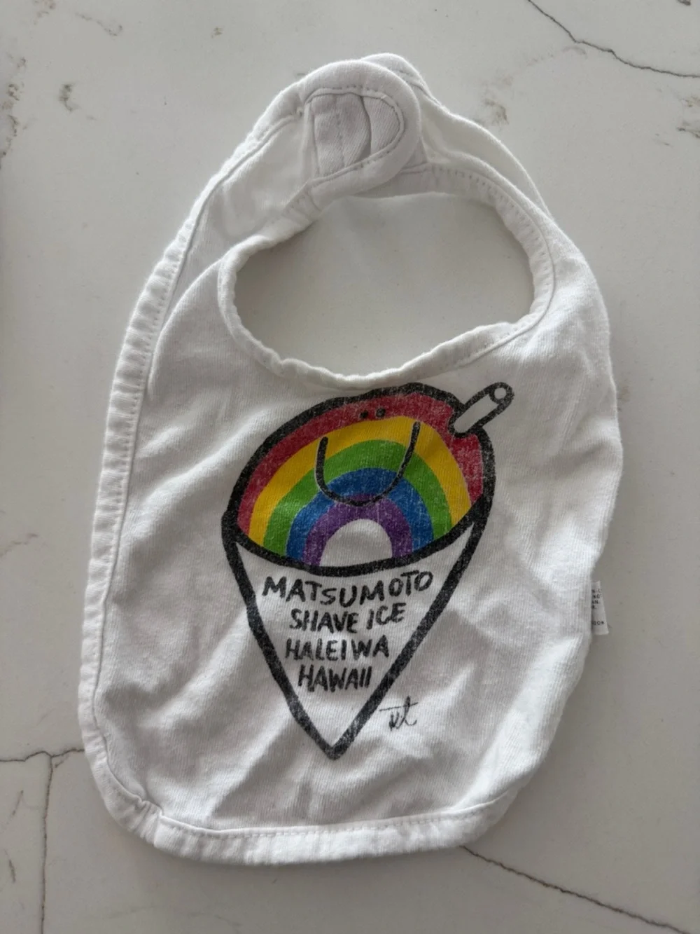 An assortment of baby bibs-Baby Gap, H&M, Matsumoto’s Shave Ice.